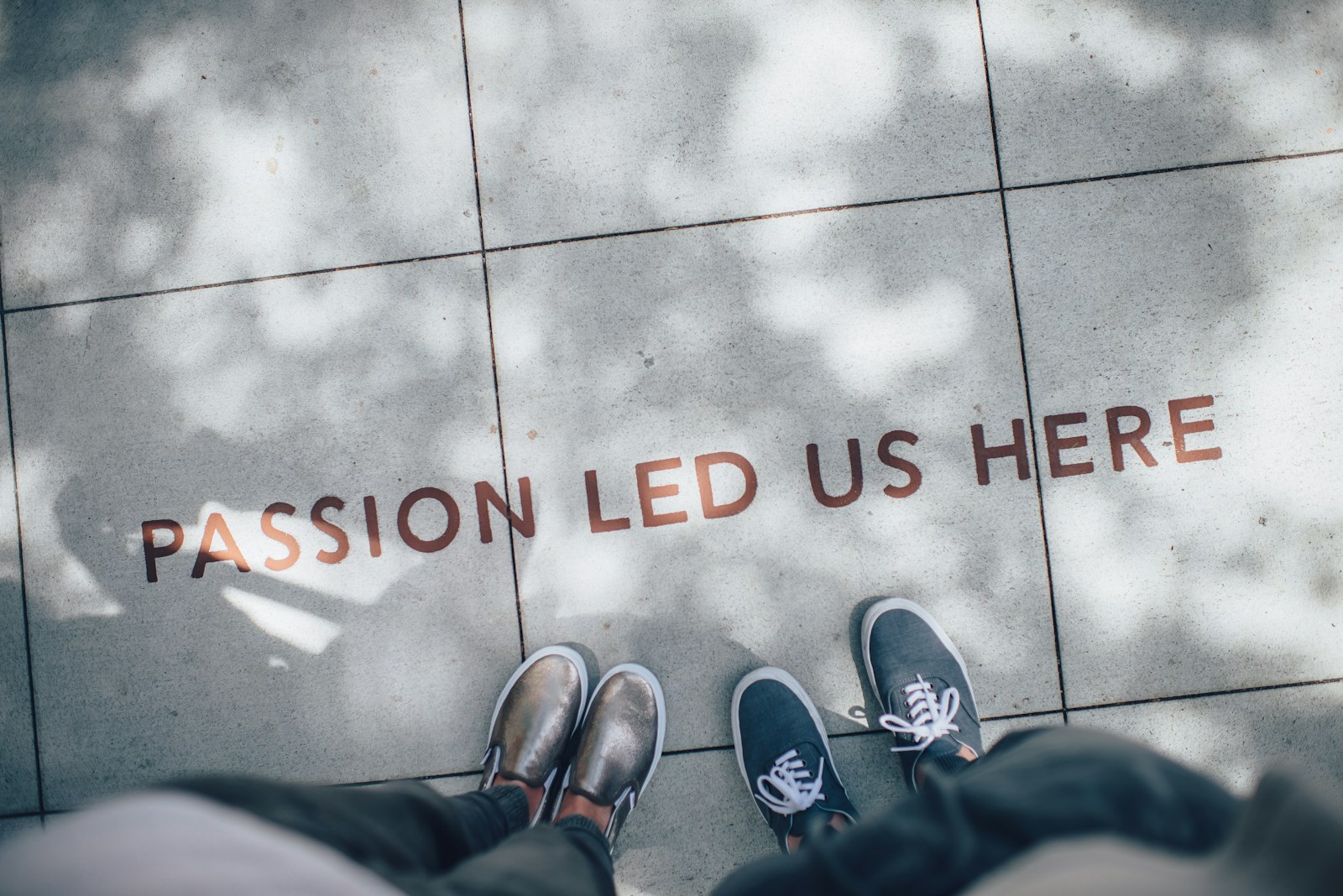 two person standing on gray tile paving; obsession changes your life